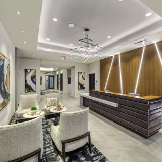 A modern lobby area with stylish furniture, contemporary artwork, and elegant lighting.
