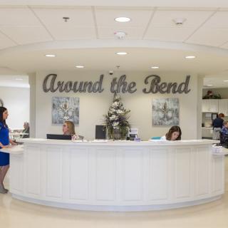 A reception desk with staff members in an office setting.