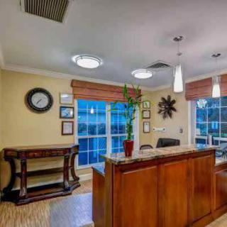A welcoming reception area with a wooden desk and decorative elements.