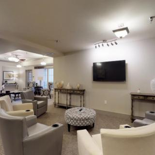 A modern living room with comfortable seating and a wall-mounted television.