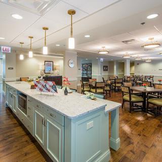 A well-lit dining area with neatly arranged tables and chairs, featuring stylish interior decor.