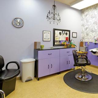 A well-decorated salon interior with styling chairs and cabinets.
