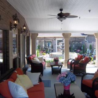 A cozy outdoor patio area with comfortable seating and decorative pillows.