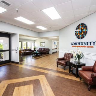A welcoming lobby with comfortable seating and bright lighting in a community center.