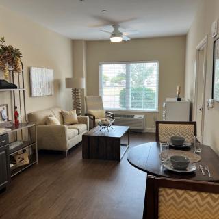 A cozy living room with a dining area featuring modern furniture and decor.