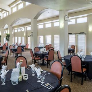 A spacious and elegant dining area with well-set tables and ample natural light.