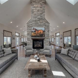 A modern living room featuring a stone fireplace, two sofas, and a wooden coffee table.