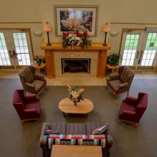 A cozy living room with a fireplace and comfortable seating arrangement.