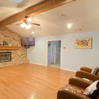 Spacious living room with a fireplace and vaulted ceiling.