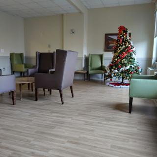 A cozy waiting area with comfortable seating and a decorated Christmas tree.