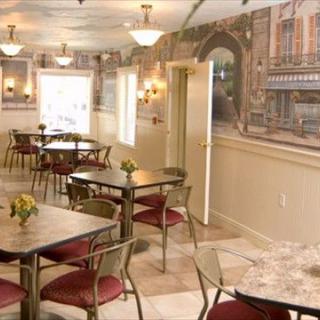 A charming cafe interior with elegant tables and artistic wall decorations.