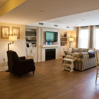 A cozy living room with a fireplace, television, and comfortable seating.