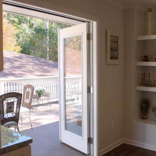 A cozy interior with French doors leading to a sunlit patio.