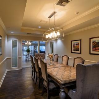 Elegant dining room with a large table, comfortable chairs, and stylish lighting.