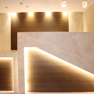 A sleek and modern reception area featuring minimalist design elements and ambient lighting.