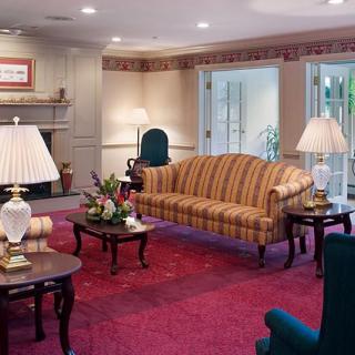 A cozy living room with classic furniture and warm lighting.