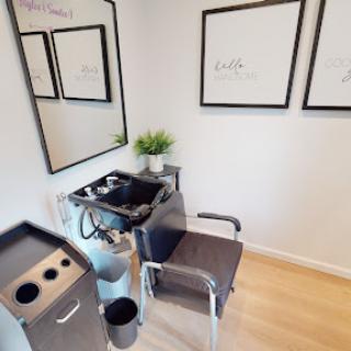 A modern hair salon station featuring minimalist decor and a stylish setup.