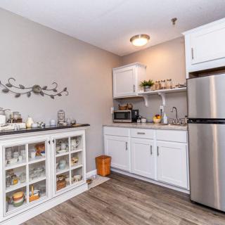 Modern kitchen with white cabinets and stainless steel appliances.