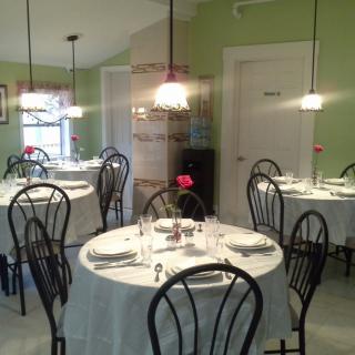 An elegant dining area set with round tables and chairs, ready for guests.