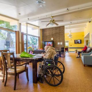 A common area in a nursing home with elderly residents relaxing and socializing.