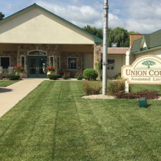 An inviting community center with well-maintained landscaping and clear signage.