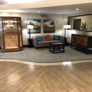 A cozy lobby area featuring a sofa, lamps, and decorative elements.