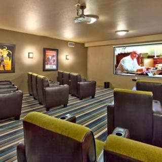 A cozy home theater setup featuring comfortable seating and a screen for movie viewing.