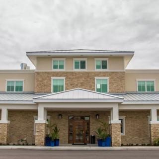 A modern commercial building with a neutral color palette and symmetrical design.
