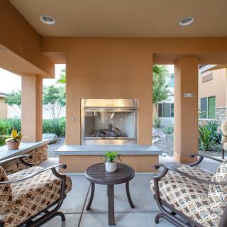 A cozy outdoor seating area featuring a modern fireplace, perfect for relaxing and enjoying the surroundings.