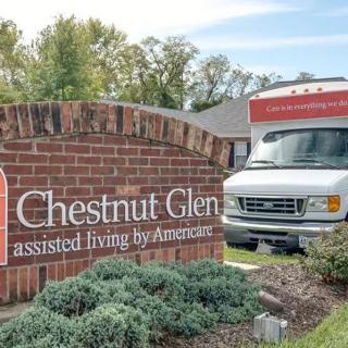 A sign for Chestnut Glen assisted living facility next to a parked van.