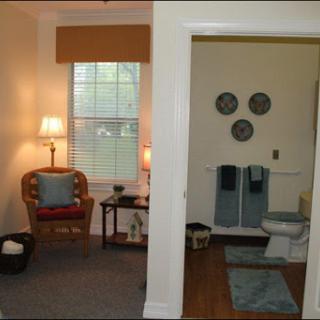 A cozy living area adjacent to a neatly designed bathroom.