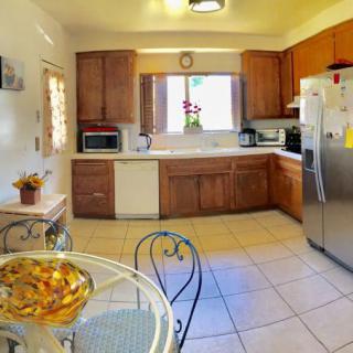 A bright kitchen with wooden cabinets, modern appliances, and a cozy dining area.