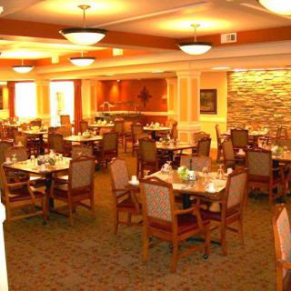 An interior view of an empty restaurant dining area with neatly arranged tables and chairs.