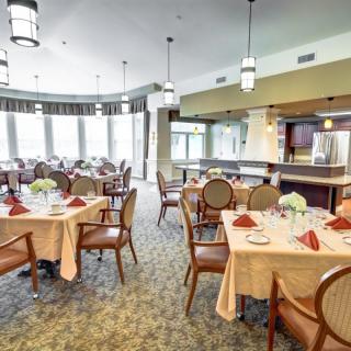 An elegant dining room with neatly arranged tables and chairs, ready for guests.