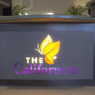 Illuminated sign displaying 'The Californian' with a leaf logo.