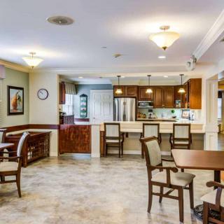 A modern kitchen and dining area with ample lighting and stylish furniture.