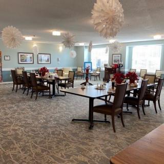 A well-decorated dining area with neatly arranged tables and chairs.