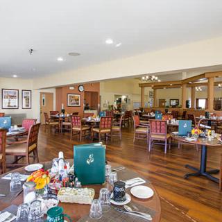 An indoor dining area with neatly arranged tables and chairs, ready for service.