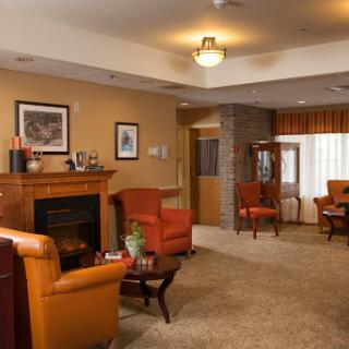 A cozy living room featuring comfortable seating and a warm fireplace.
