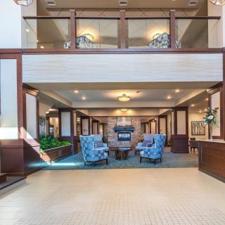 Elegant hotel lobby with comfortable seating and chandeliers.