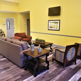 A cozy living room with warm yellow walls and comfortable furniture.