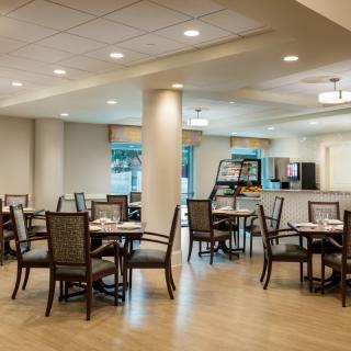 A modern and spacious dining area with neatly arranged tables and chairs.