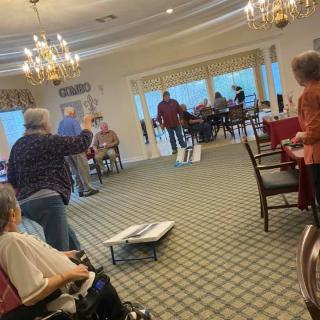 A group of people playing an indoor game in a communal setting.