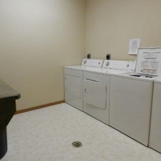 A clean and organized laundry room with a washer and dryer setup.