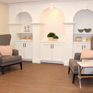 A modern living room setup featuring comfortable seating and elegant shelving.