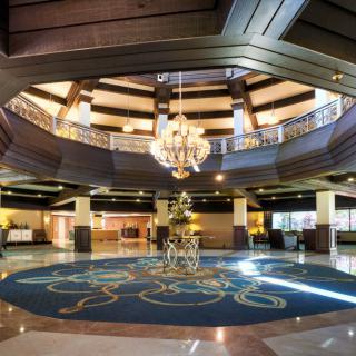 A luxurious hotel lobby featuring a grand chandelier and elegant interior design.