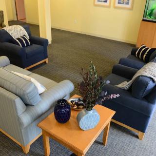 A cozy living room setup featuring sofas and a coffee table with decorative items.