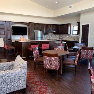 A modern and stylish interior featuring a kitchen and dining area with comfortable seating.