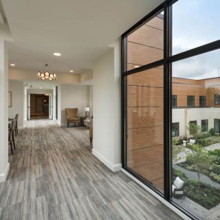 A modern hallway with large windows and natural light.