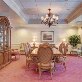 Elegant dining room with a chandelier and classic furniture.